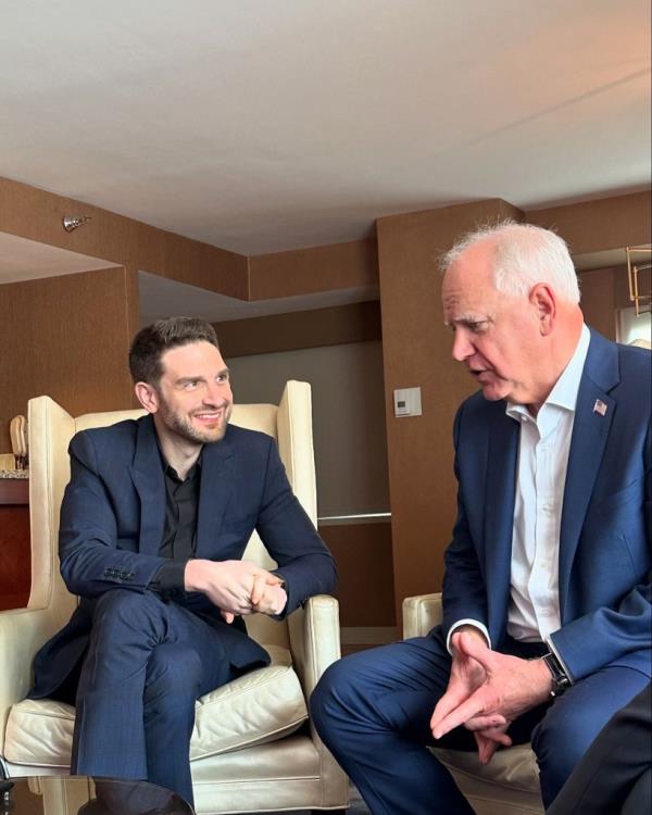 Alexander Soros and Tim Walz sitting in chairs at the Democratic National Convention in Chicago